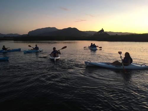 Group of hikers in canoes during excursion to Posada at sunset
