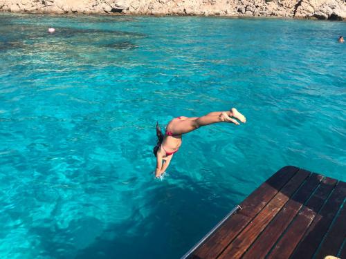 Girl dives from a motor yacht