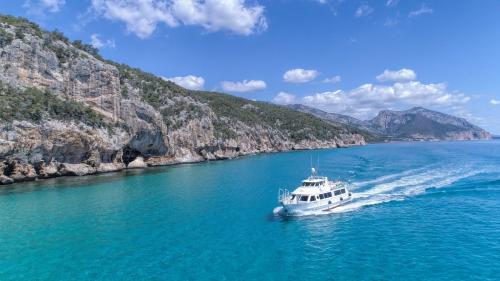 Motor ship sails in the Gulf of Orosei