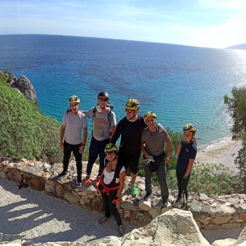 People in Cala Gonone during a bike excursion