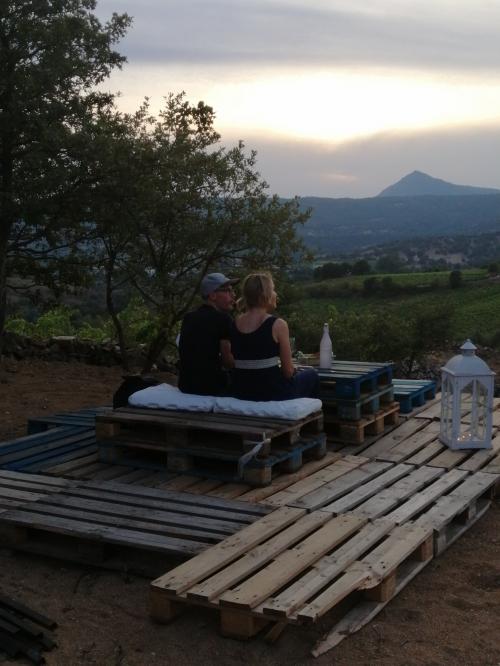 Hikers relax during food and wine experience in a vineyard in Mamoiada