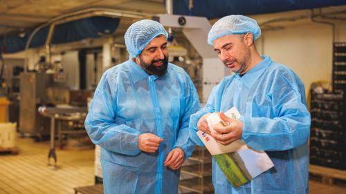 The guide shows the cheese to a participant