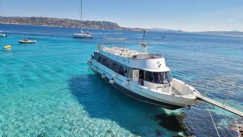 Motor ship arrives on an island of the La Maddalena Archipelago
