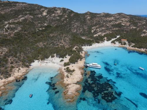 Motor ship stops on an island of the La Maddalena Archipelago