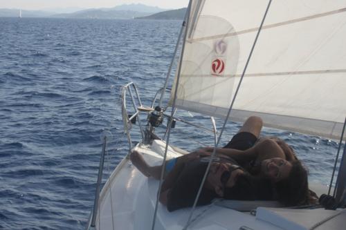 Couple relaxes aboard a sailboat