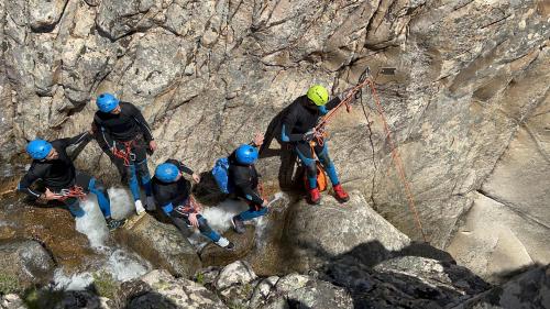 Hikers rappel with rope