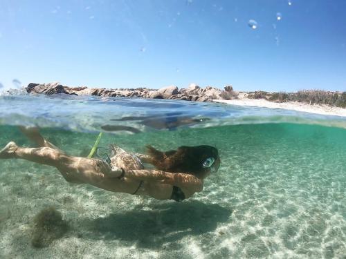 Girl swims in the crystal clear sea