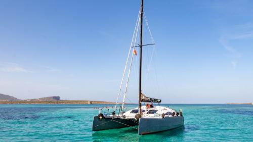 Catamaran in the blue waters of Fornelli