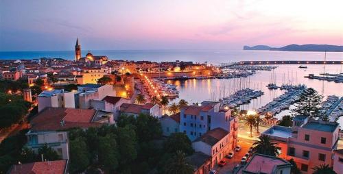 Overview of the city of Alghero at sunset