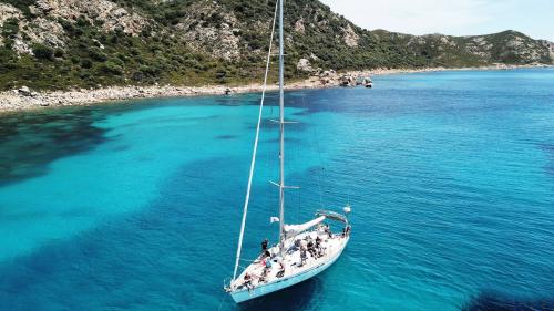 Sailboat in the crystal clear sea of the La Maddalena Archipelago