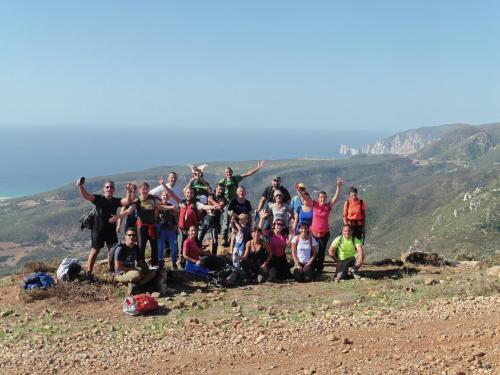 Panoramic photo with group of happy travelers after the hike