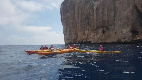 People kayaking among the most beautiful coves on the coast of Alghero