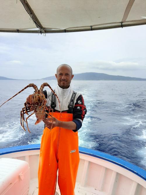 Capitán con langosta recién pescada