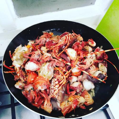 Pot with seafood cooked on board