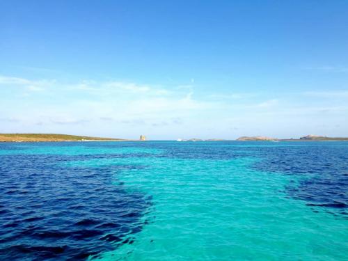 Blue water in the Gulf of Asinara with turret on the horizon