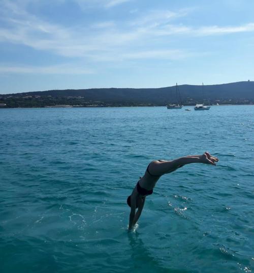 Girl dives from the wooden goiter