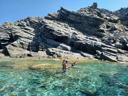 Hikers swim in the waters of the island of Asinara