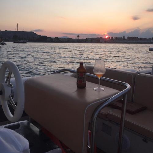 Aperitif on board an inflatable boat at sunset