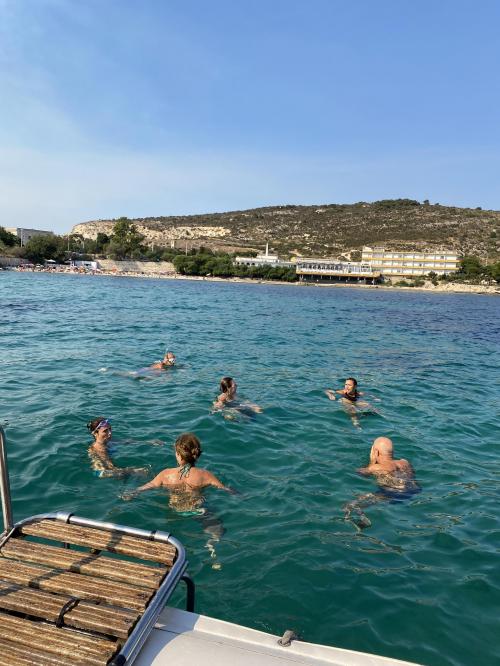Hikers take a swim in the Gulf of Cagliari