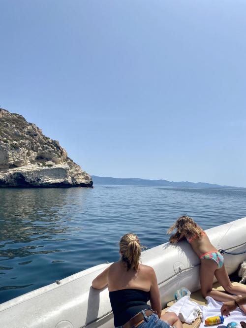 Girls look at the view from the dinghy