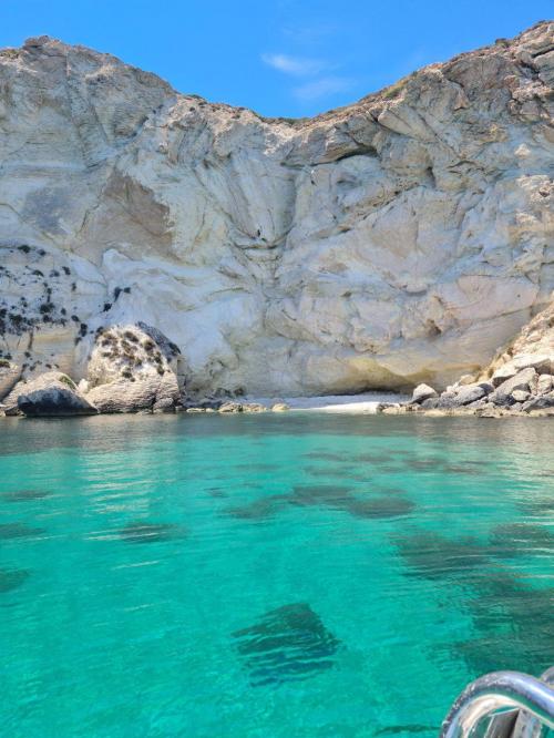 Hidden cove with rocky wall and blue water in the Gulf of Cagliari