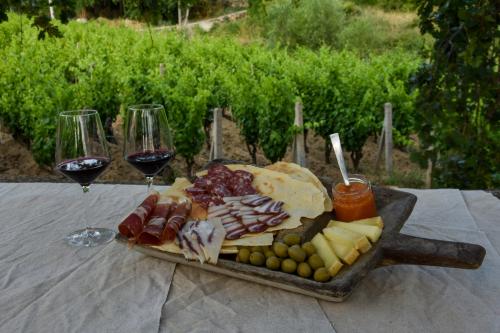 cold cuts and cheese board as an aperitif with glasses of red wine