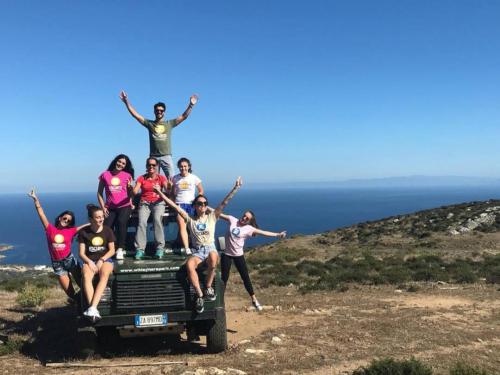 Off-road vehicles in Asinara and hikers