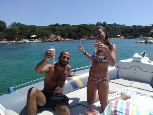 Couple aboard an inflatable boat makes an aperitif