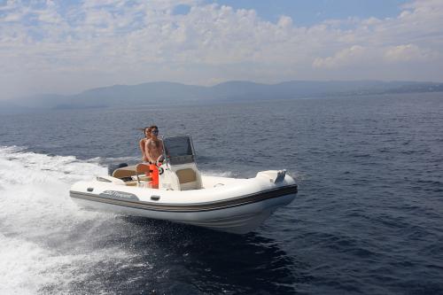 Couple in rubber dinghy in La Maddalena Archipel