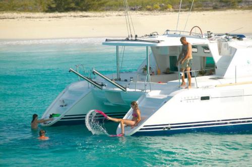 Family aboard a catamaran and in the water in the La Maddalena Archipelago