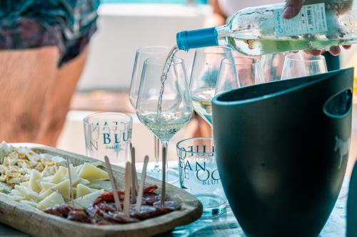 Aperitif with local products and white wine on a sailing boat in Asinara